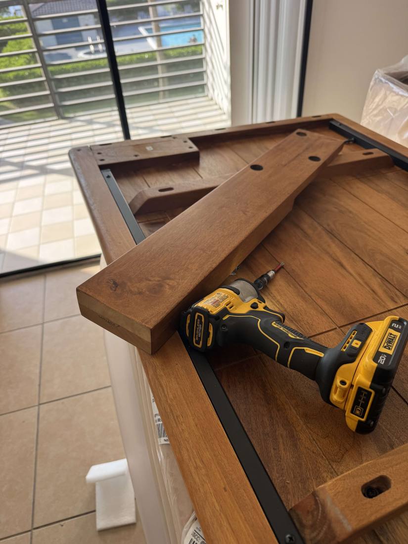 Wood table being assembled with a power drill