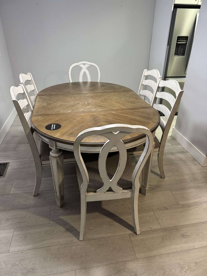 Dining table and six chairs set up in a kitchen